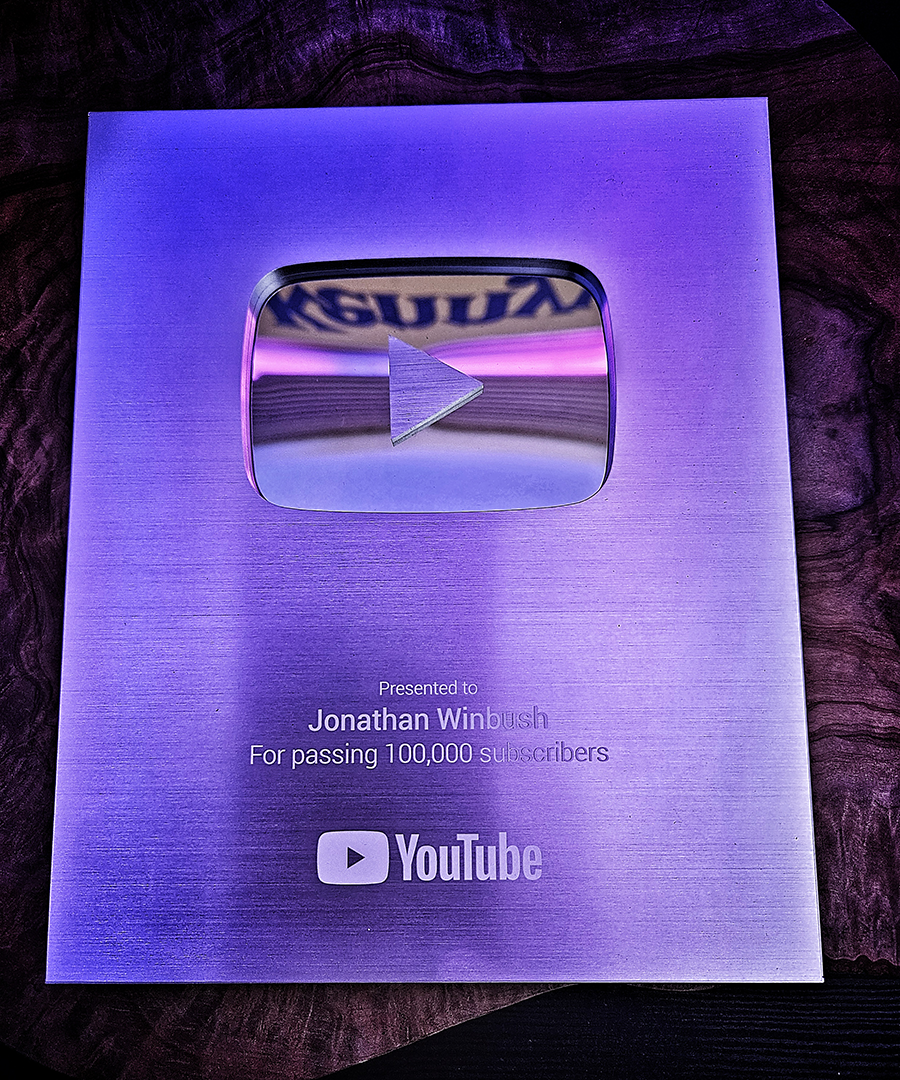 Winbush holding his YouTube Creator Award plaque